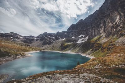 Scenic view of lake and mountains against sky