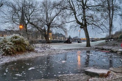 View of frozen river in city