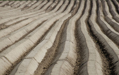 Full frame shot of tire tracks on sand