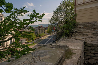 Street by buildings against sky