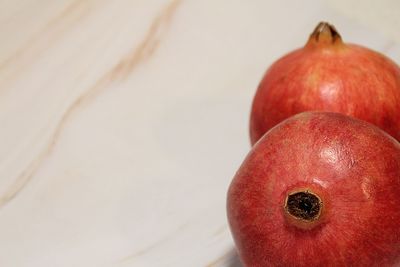 Close-up of apple on table against white background