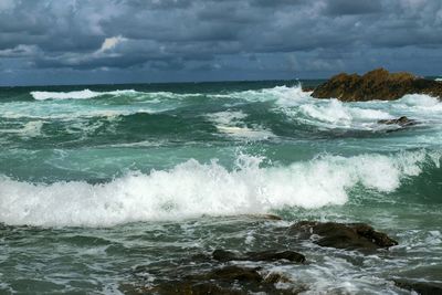 Scenic view of sea against cloudy sky