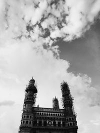 Low angle view of building against cloudy sky