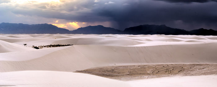 Scenic view of mountains against cloudy sky