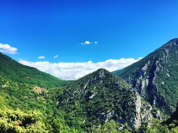 Scenic view of mountains against blue sky