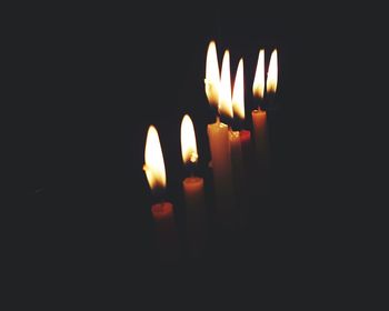 Close-up of burning candle in darkroom