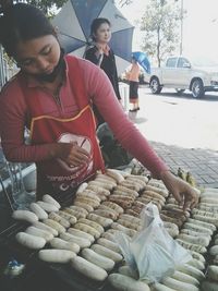 Young man having food on street