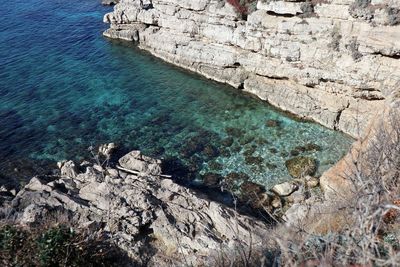 High angle view of rocks by sea