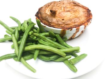 Close-up of burger in plate against white background