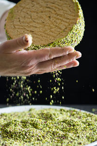 Close-up of chef's hands making cake