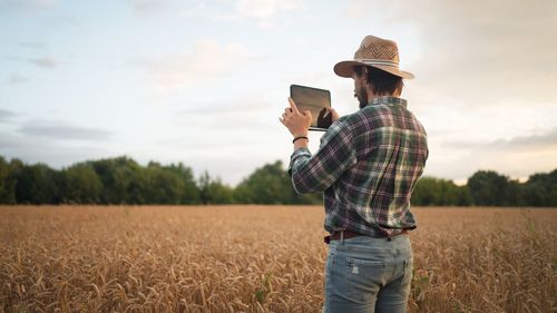Rear view of man standing on field