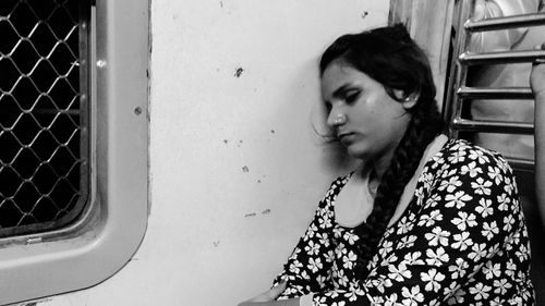 Young woman sleeping while traveling in train