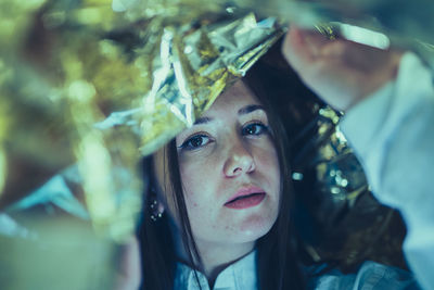 Close-up portrait of young woman smoking outdoors