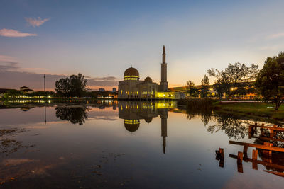 Reflection of building in lake at sunset