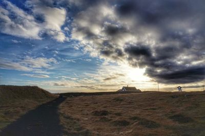 Scenic view of landscape against cloudy sky