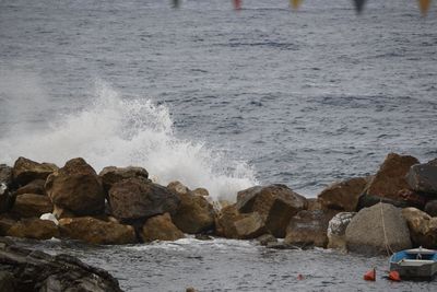 Scenic view of rocks on sea shore