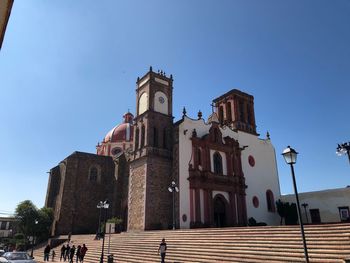 Low angle view of building against clear blue sky