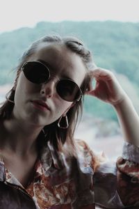 Portrait of young woman wearing sunglasses outdoors