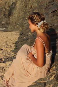 Rear view of woman standing at beach