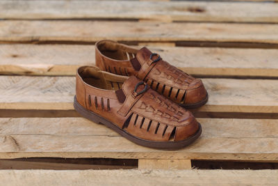 High angle view of shoes on wooden table