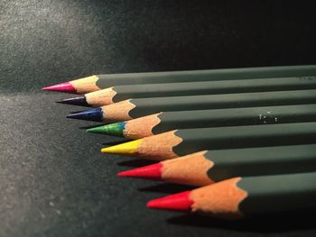 Close-up of colorful pencils arranged on table