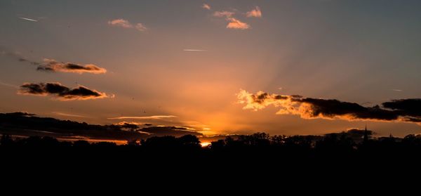 Silhouette of trees against sky at sunset