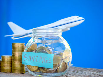 Close-up of coins on table against blue background