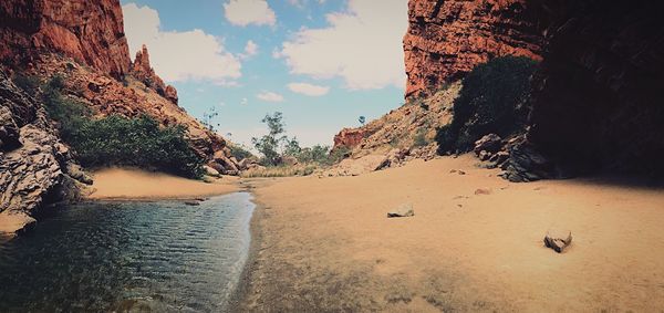 Panoramic shot of rocks on beach against sky