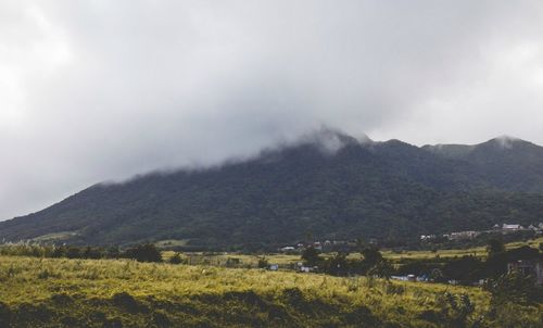 Scenic view of mountains against cloudy sky