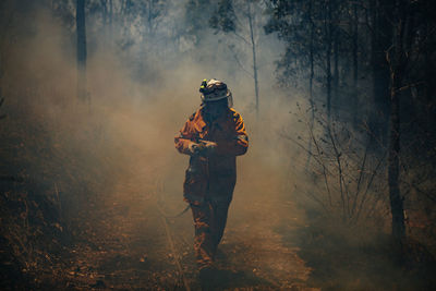 Full length of man standing on field in forest