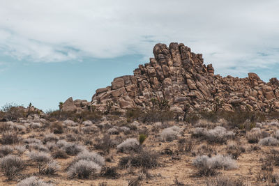 Rock formations on landscape against sky