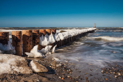 Panoramic shot of frozen lake against sky