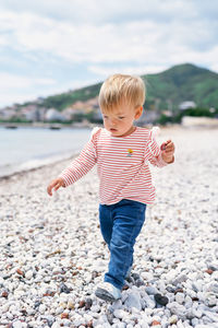 Full length of boy standing on beach