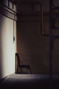 Empty chair against wall at home