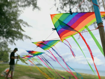 Close-up of multi colored flags against sky