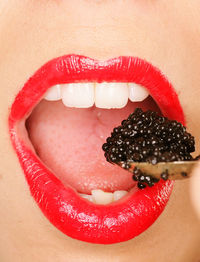 Close-up of woman eating caviar