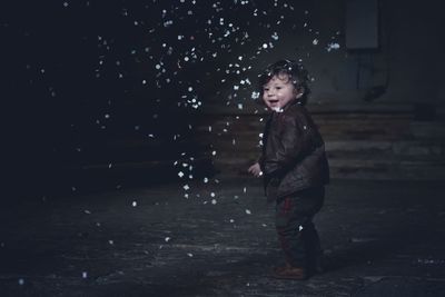 Portrait of happy boy standing at night