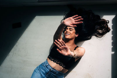 High angle view of woman lying down on floor