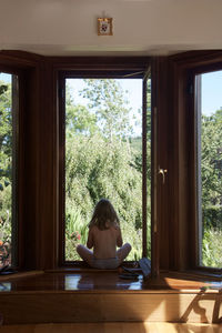 Portrait of boy sitting in window