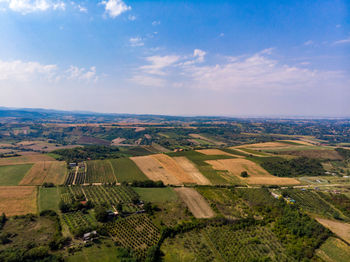 Aerial view of agricultural field against sky