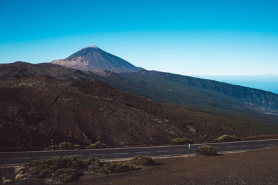 Scenic view of mountains against clear blue sky