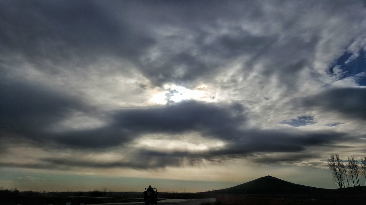 silhouette, sky, cloud - sky, cloudy, beauty in nature, sunset, weather, scenics, tranquil scene, tranquility, nature, cloud, dramatic sky, overcast, landscape, dusk, cloudscape, storm cloud, idyllic, outdoors