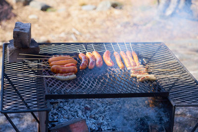 Grilled sausages outdoor on vintage rusted grill.