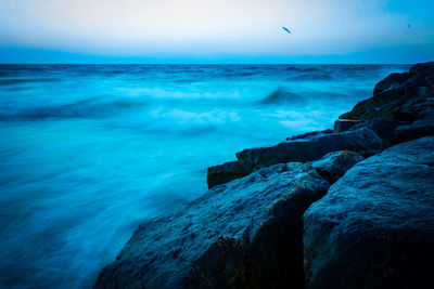 Scenic view of sea against clear blue sky