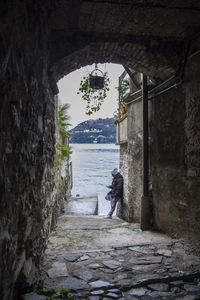 Man by sea against sky