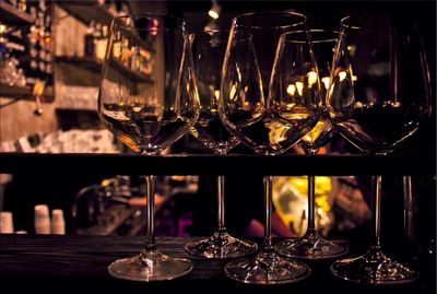 Close-up of wineglasses on shelf