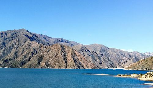 Scenic view of mountains against clear blue sky