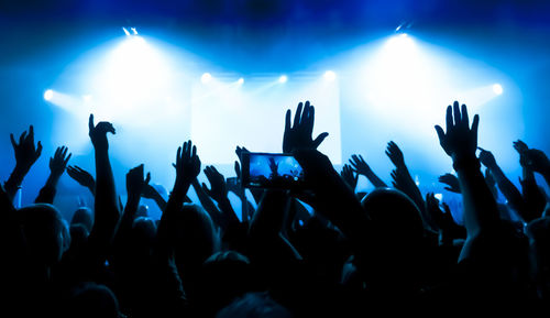 Crowd of people dancing at concert