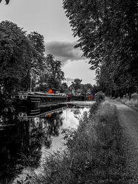 View of canal against cloudy sky