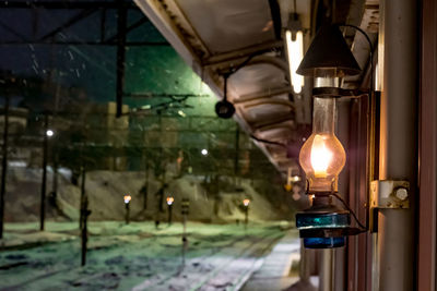 Low angle view of illuminated light bulbs hanging from ceiling